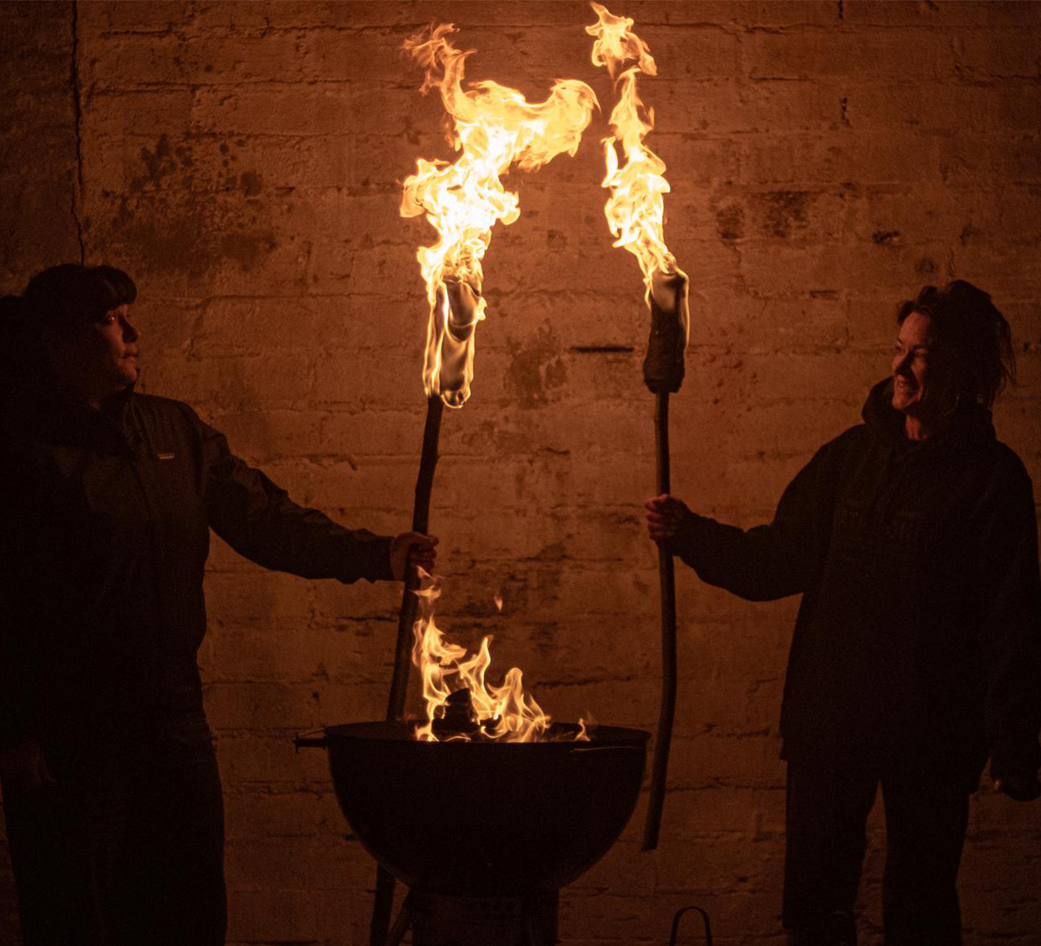 Smoke Signals Arundel BBQ event with two event organisers holding flaming torches